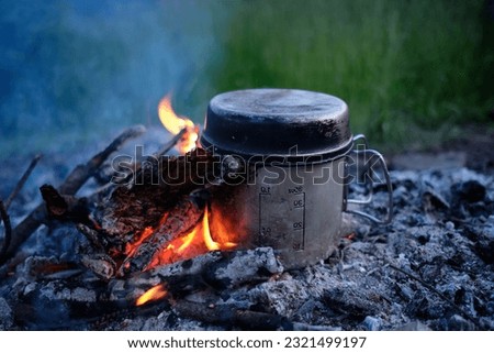 Making coffee or tea on the fire of nature. Burning fire. A place for fire. Ashes and coal.Active Lifestyle Concept.