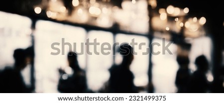 Rain drop on window glass of coffee shop and blurry city life background. Rainy season and blurry people city day life or bokeh night lights outside window. Coffee shop window covered with rain water Royalty-Free Stock Photo #2321499375