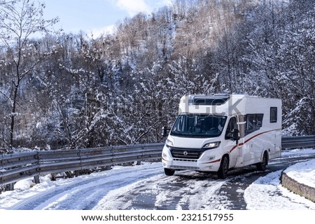 Campervan on a snowy road in Italy Royalty-Free Stock Photo #2321517955