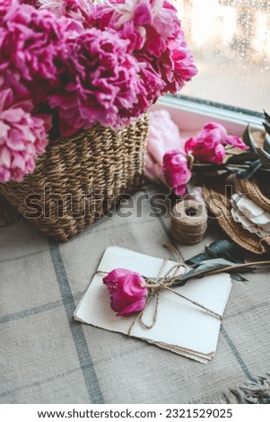 Craft letters and pink peony, spring composition.