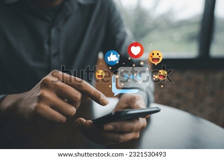Businessman holding smartphone for social media marketing and online advertising. Digital concept of data transfer and communication. Social Distancing and Working From Home Royalty-Free Stock Photo #2321530493