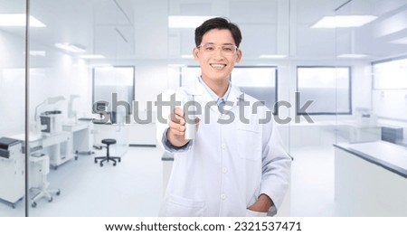 Portrait photo of a young handsome Asian male scientist in laboratory, white background. Concept of proving a healthy product Royalty-Free Stock Photo #2321537471
