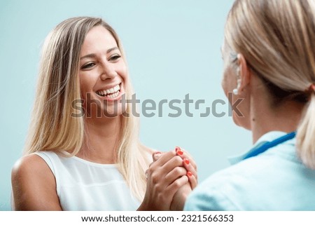 Blonde physician with her patient, caring for her physically and emotionally. Their relationship built on trust and true concern Royalty-Free Stock Photo #2321566353