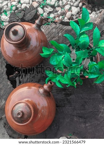 Close up picture The twin jugs traditional beside limes tree after rain on the wooden table background. 