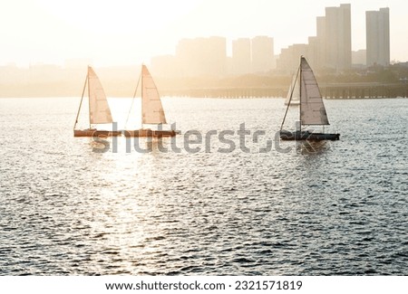 Sailboat in the sea at sunset.