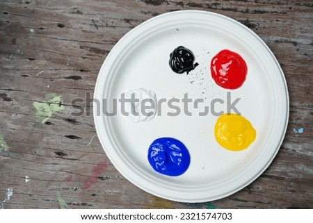 Paper trays for putting paints for painters Mix the colors to draw and paint into your favorite image. many watercolors in tray, blue, red, yellow, white, black, waiting to be mixed to get new color.