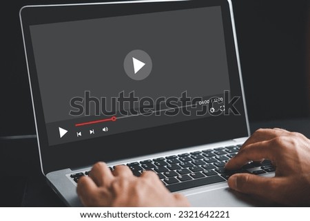 Webinar and online education come to life as a man works on his laptop computer, watching video tutorials and mastering new skills from the digital realm of technology. Royalty-Free Stock Photo #2321642221