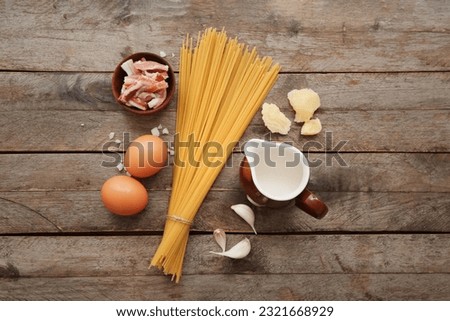Ingredients for tasty pasta carbonara on wooden background