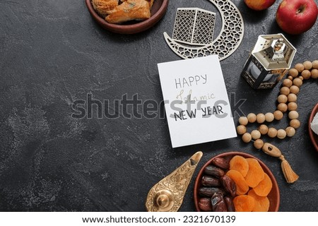 Card with text HAPPY ISLAMIC NEW YEAR, dried fruits and tasbih on dark background Royalty-Free Stock Photo #2321670139