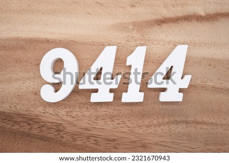 White number 9414 on a brown and light brown wooden background.