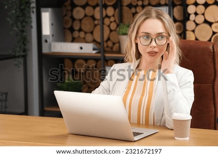 Young businesswoman working with laptop in office