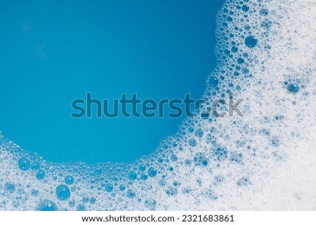 Detergent foam bubble on water. Blue background, Soap sud Royalty-Free Stock Photo #2321683861