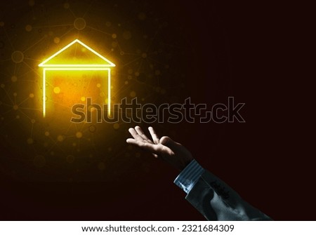 Hand of businessman touching with finger glowing home icon or symbol