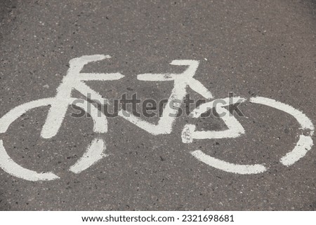 White bicycle print on asphalt bike path
