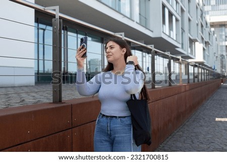 a girl takes a selfie on the street
