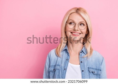 Photo of retired healthy lady beaming smiling look side oculist promotion wear spectacles jeans shirt isolated pink color background