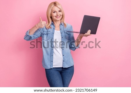 Photo of wearing stylish denim outfit woman retired thumb up customer feedback new laptop efficiency isolated on pink color background