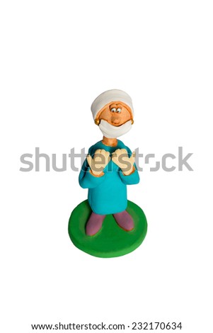Clay statuette a woman surgeon with the lifted gloved hands in a mask isolated on a white background