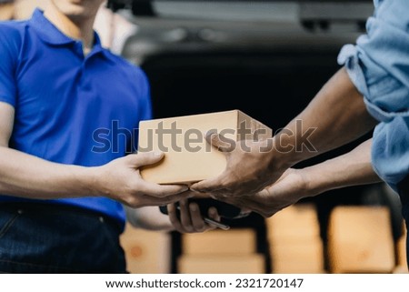 Male hand accepting delivery of box from delivery man in the morning.