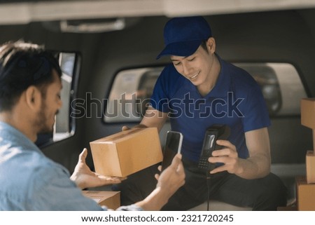 Asian delivery man, Hand using smart phone to scan QR code on tag, concept of parcel delivery, Qr code payment concept.