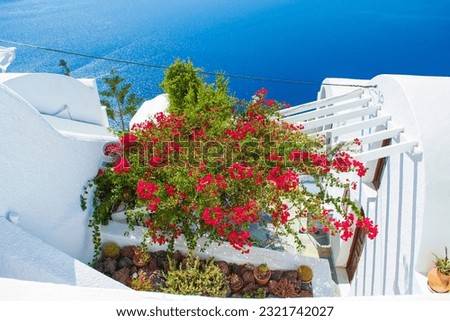 Amazing view to Aegean Sea from beautifully decorated rooftop of a dazzling white cave house on the picturesque Santorini island cliffs,Cyclades Greece.Picture taken on September 7th 2013