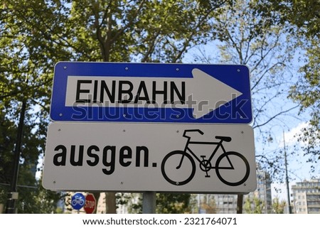 A traffic sign in Austria indicating a one way street with an arrow pointing right above a bike sign