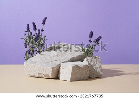 Abstract background minimal presentation with lavender flower. On a purple background, fresh blooming lavender displayed with blocks of stone. The scent of lavender can improve sleep quality Royalty-Free Stock Photo #2321767735