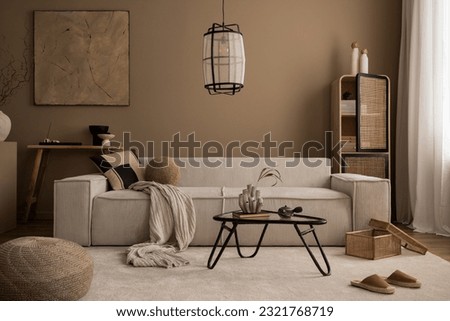 Interior design of living room with mock up poster frame, beige sofa, glass coffee table, beige wall, pouf, rattan sideboard, slippers, wooden bench and personal accessories. Home decor. Template.