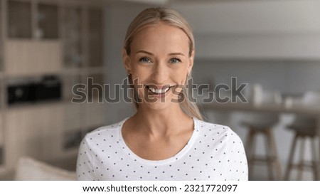 Head shot portrait of smiling young woman looking at camera feeling positive, happy friendly female making video call, chatting online with friends or dating, popular blogger recording video