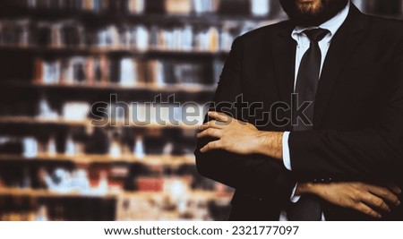 Black suit-clad businessman or lawyer standing with confidence against background of business or law school library, concept of professionalism and success in MBA or law degree. Equilibrium