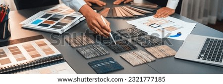 Group of interior designer team in meeting, discussing with engineer on interior design and planning for house project blueprint and model, choosing various mood board materials. Insight Royalty-Free Stock Photo #2321777185