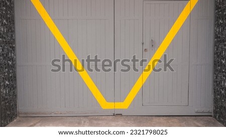 Yellow line in grey timber door