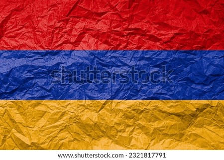 Flag of Armenia on crumpled paper. Textured background.
