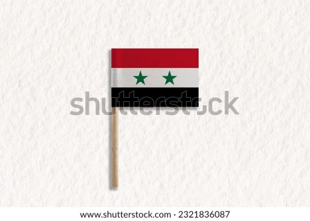 The Flag of Syria with Wooden Pole on White Paper.