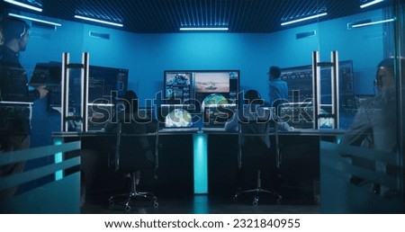 Team watch successful space rocket launch on big digital screens in mission control center. Diverse flight control workers in front of computers monitor crewed mission. Scientific space exploration. Royalty-Free Stock Photo #2321840955