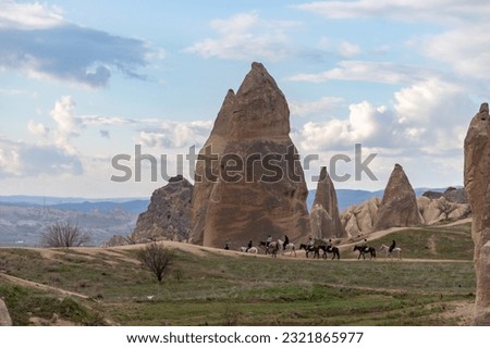 A picture of a horse tour happening on the Sword Valley, part of the Goreme Historical National Park.