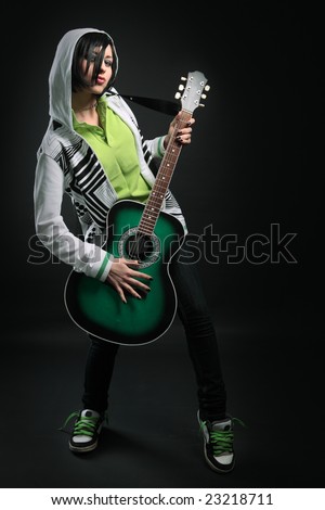 beauty emo girl with guitar on black background