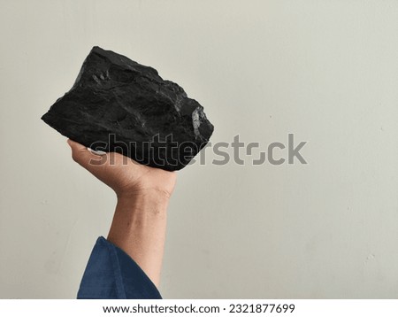 Coal mining : coal miner in the man hands of coal background. Picture idea about coal mining or energy source, environment protection. Industrial coals. Volcanic rock. Panorama photo