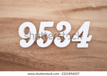 White number 9534 on a brown and light brown wooden background.