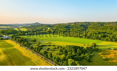 Panoramic landscape of Bohemian Paradise at sunrise time on sunny day. With Trosky castle ruins and Hruba Skala castle and sandstone rocks, Czech Republic. Aerial view from drone. Royalty-Free Stock Photo #2321897047