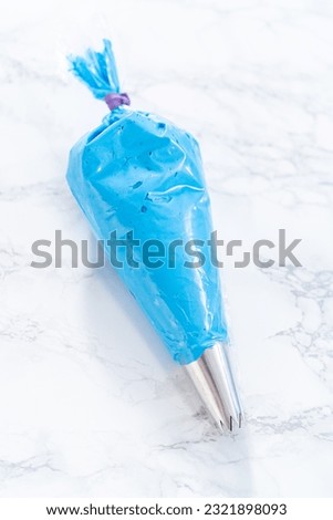 Buttercream frosting in a piping bag for decorating a cake.