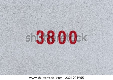 Red Number 3800 on the white wall. Spray paint.
