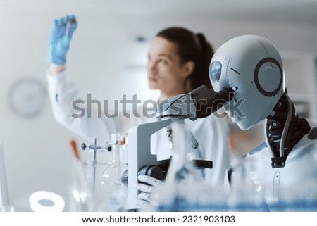 Female scientist and AI robot working together in the science lab Royalty-Free Stock Photo #2321903103