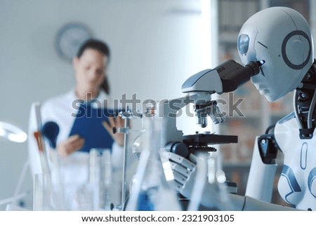 Female scientist and AI robot working together in the science lab Royalty-Free Stock Photo #2321903105