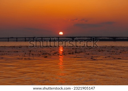 Panoramic view of the city of Dnipro during sunset or sunrise. Amazing sunset at Dnipro river with a view of the historical center. Warm days. background image. Ukrainian city.