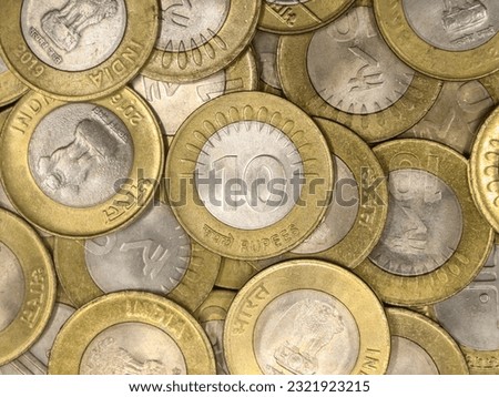 a mixed collection of rare vintage indian bimetallic 10 (ten) rupee coins gold and silver in a pile  Royalty-Free Stock Photo #2321923215