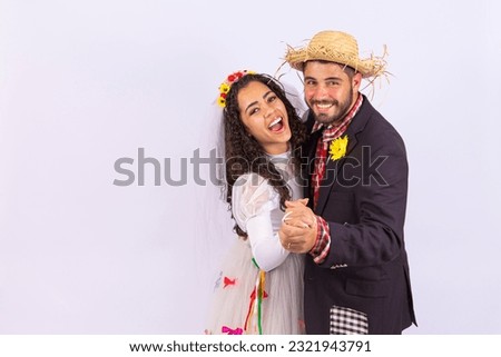 Brazilian couple wearing traditional clothes for Festa Junina dancing. 