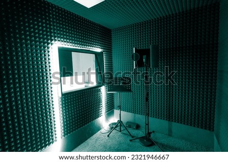 empty recording studio with professional equipment microphone stand sound engineer window green neon light