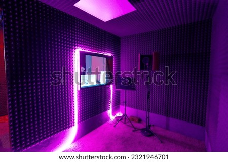 empty recording studio with professional equipment microphone stand sound engineer window purple neon light