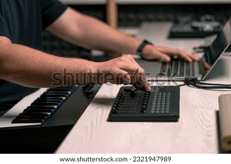 professional recording studio sound engineer with finger adjusts volume level mixing console equalizer making music Royalty-Free Stock Photo #2321947989